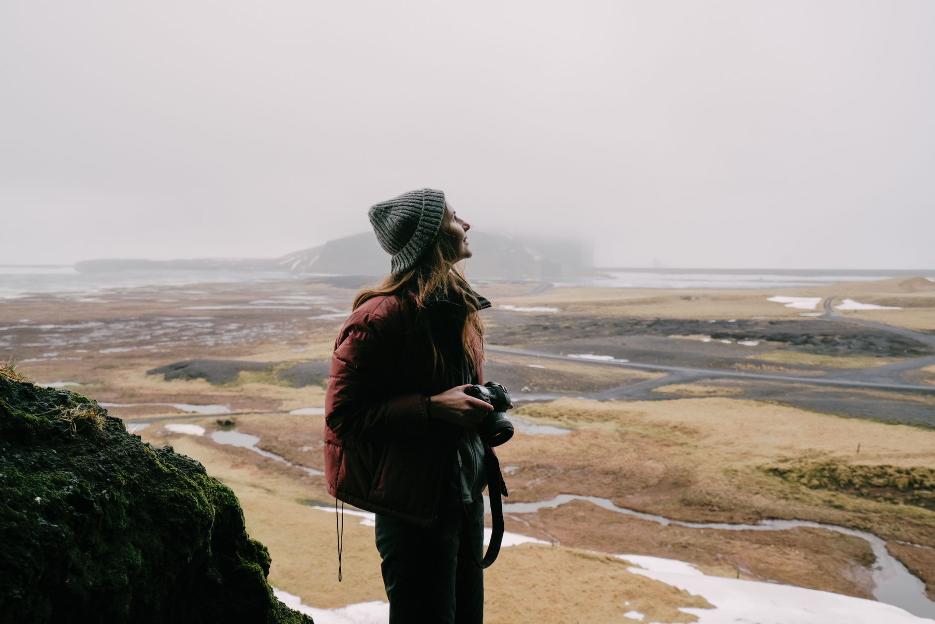 Travel writer with notebook overlooking misty valley