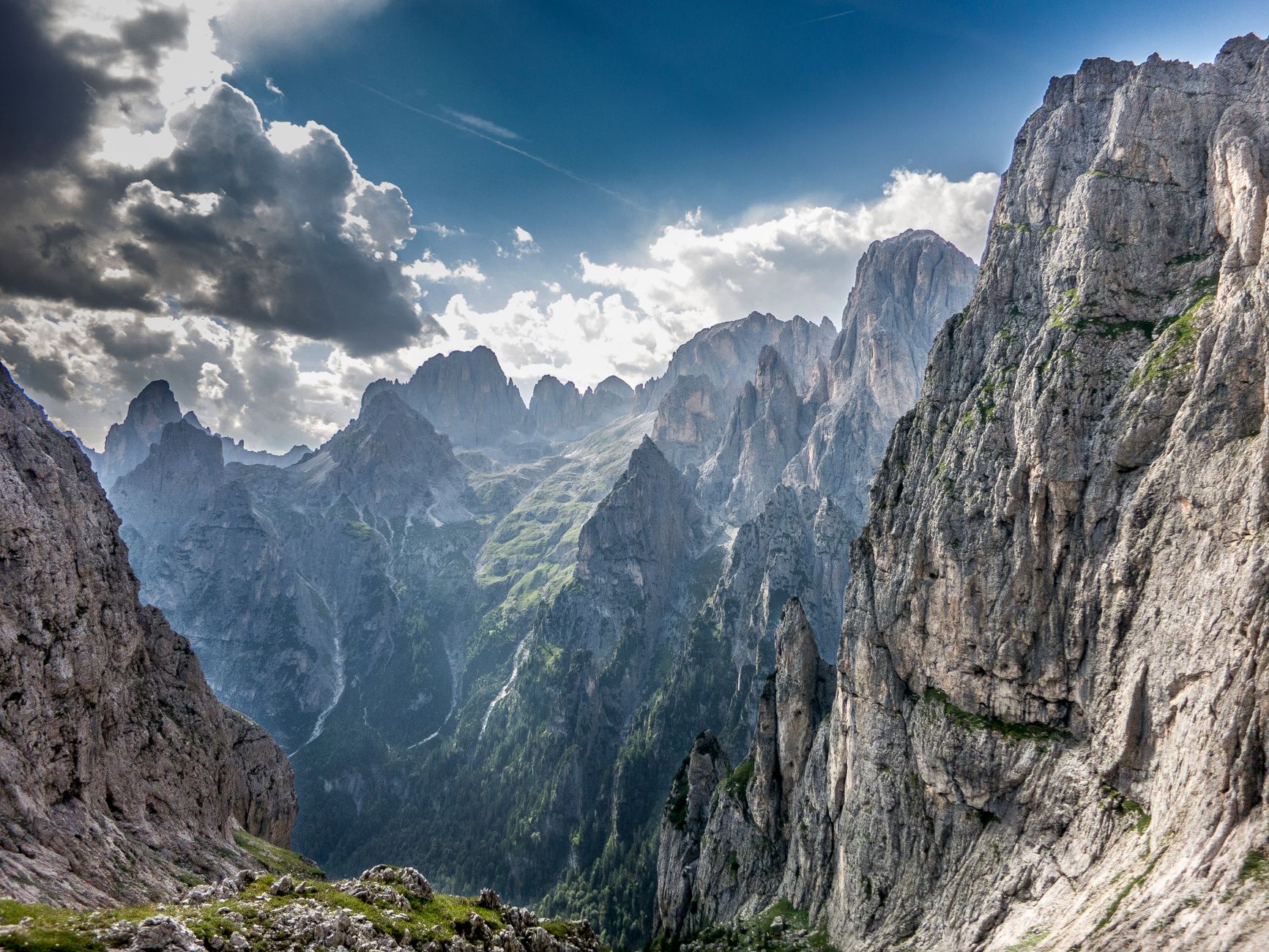 Jagged mountain peaks emerging through light clouds