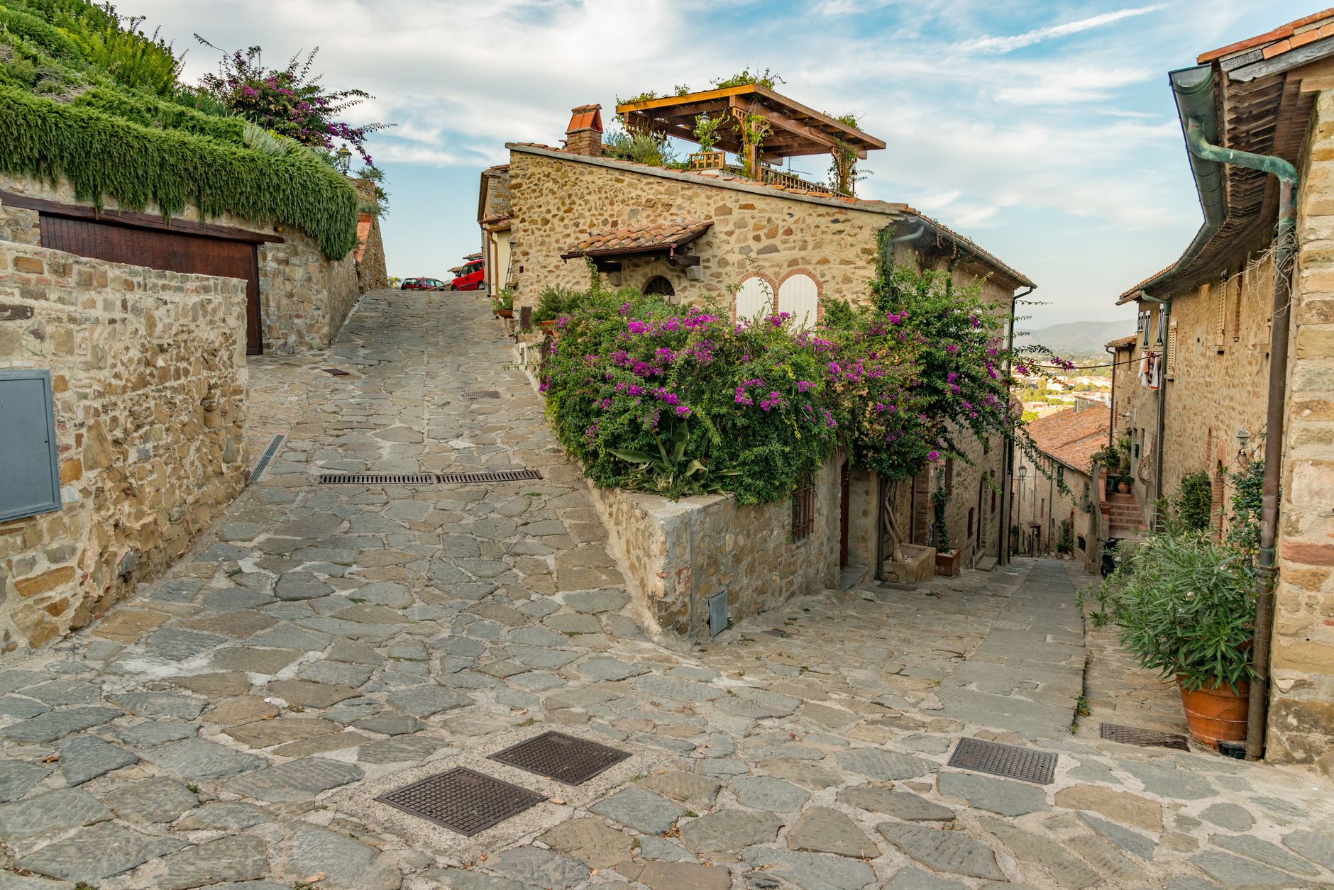 Ancient stone street in European village with mountain background